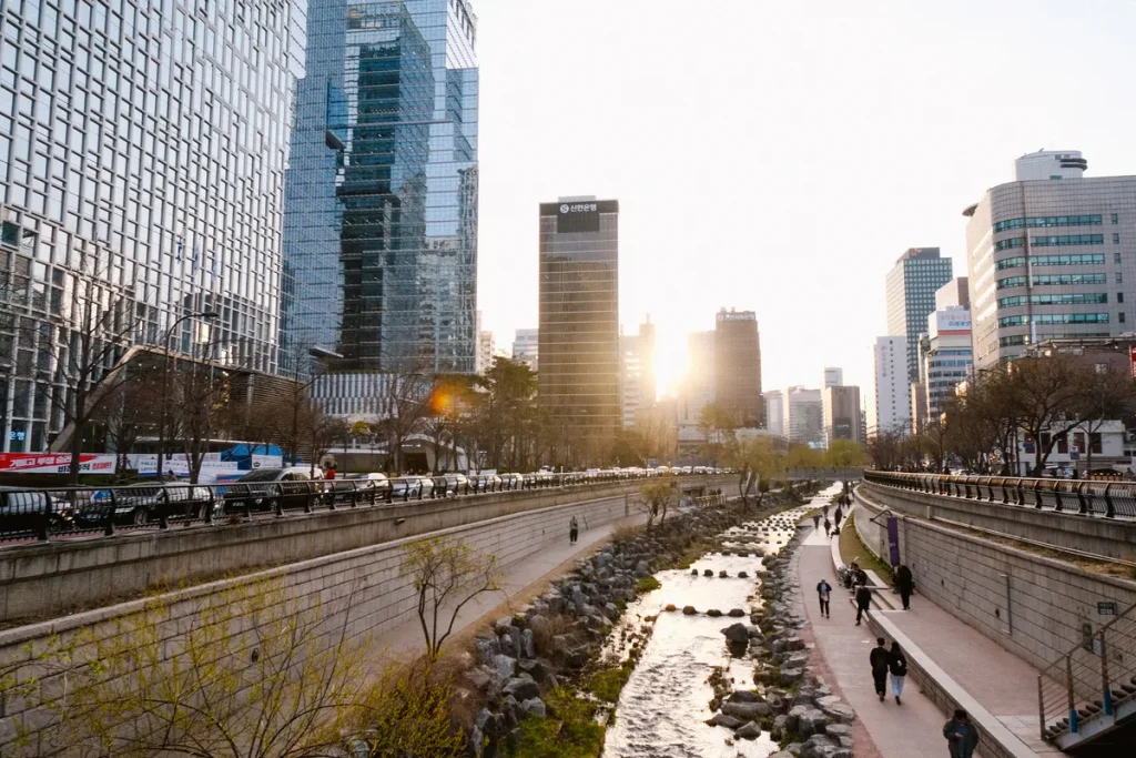 Cheonggyecheon Stream running between central Seoul buildings near sunset