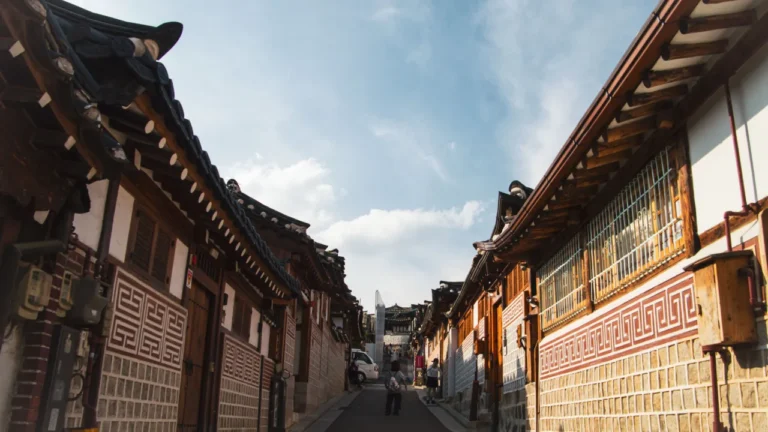Traditional hanok houses lining a sunlit street in Bukchon, Seoul