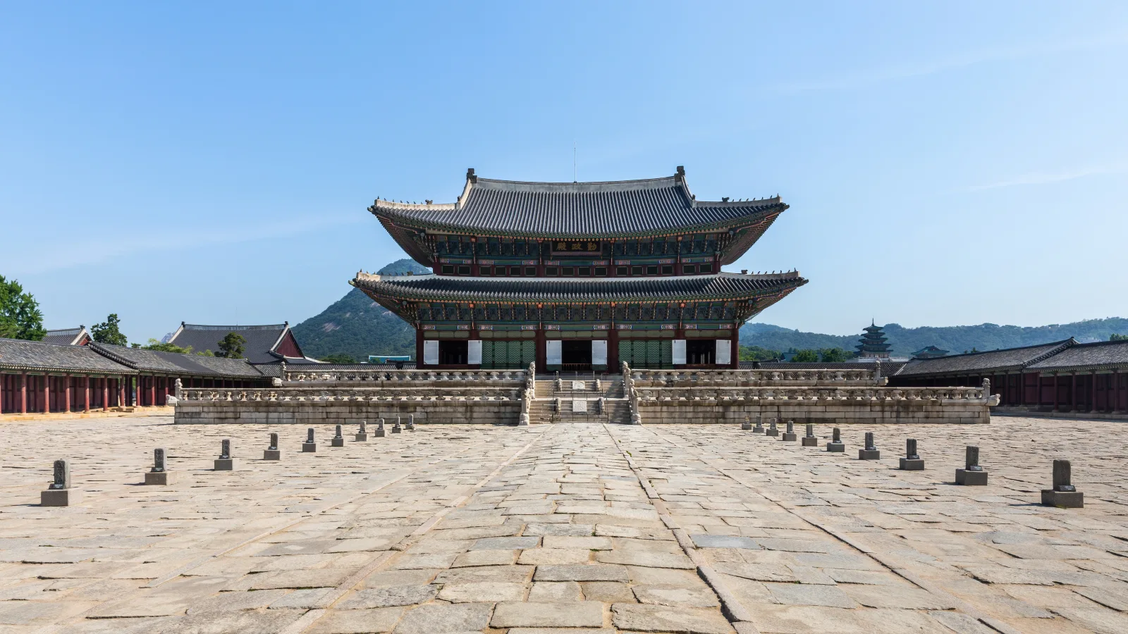 Geunjeongjeon throne hall and its stone courtyard at Gyeongbokgung Palace under a clear blue sky