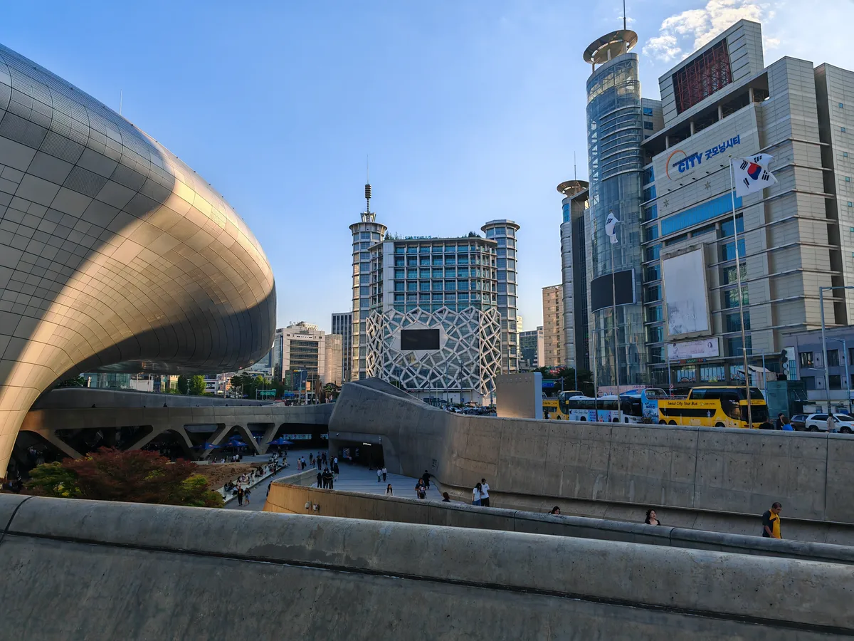 Dongdaemun Design Plaza and the surrounding shopping buildings in daylight