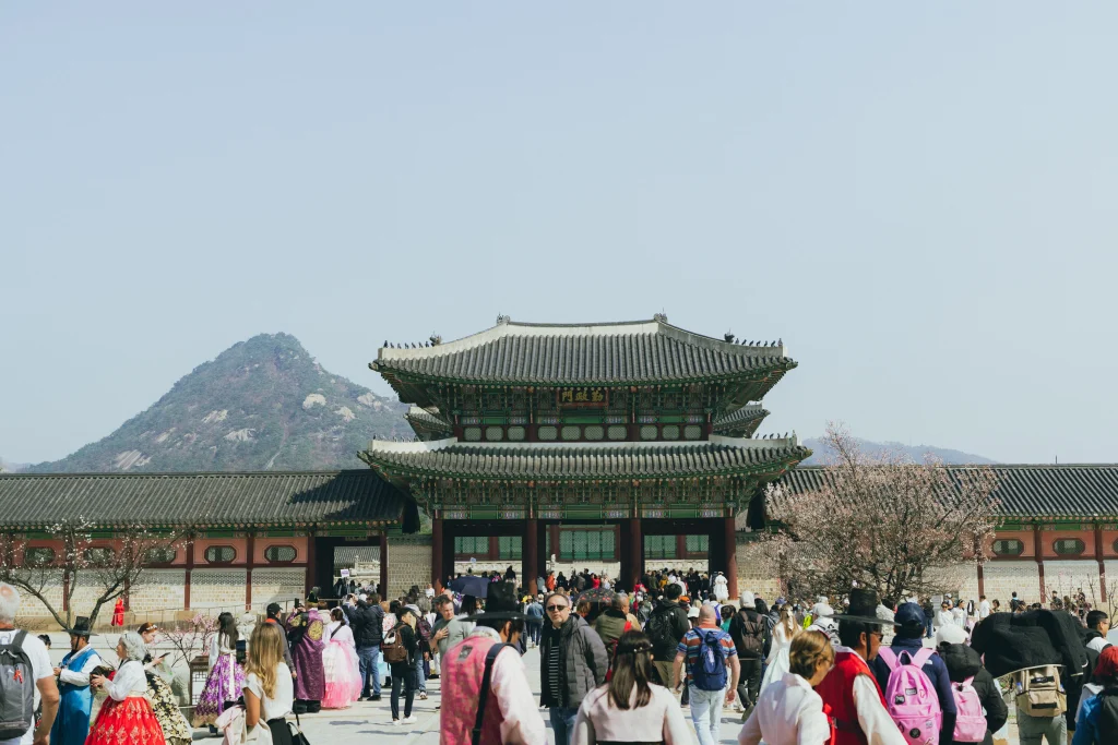 Gyeongbokgung Palace gate with Bugaksan mountain and visitors in spring