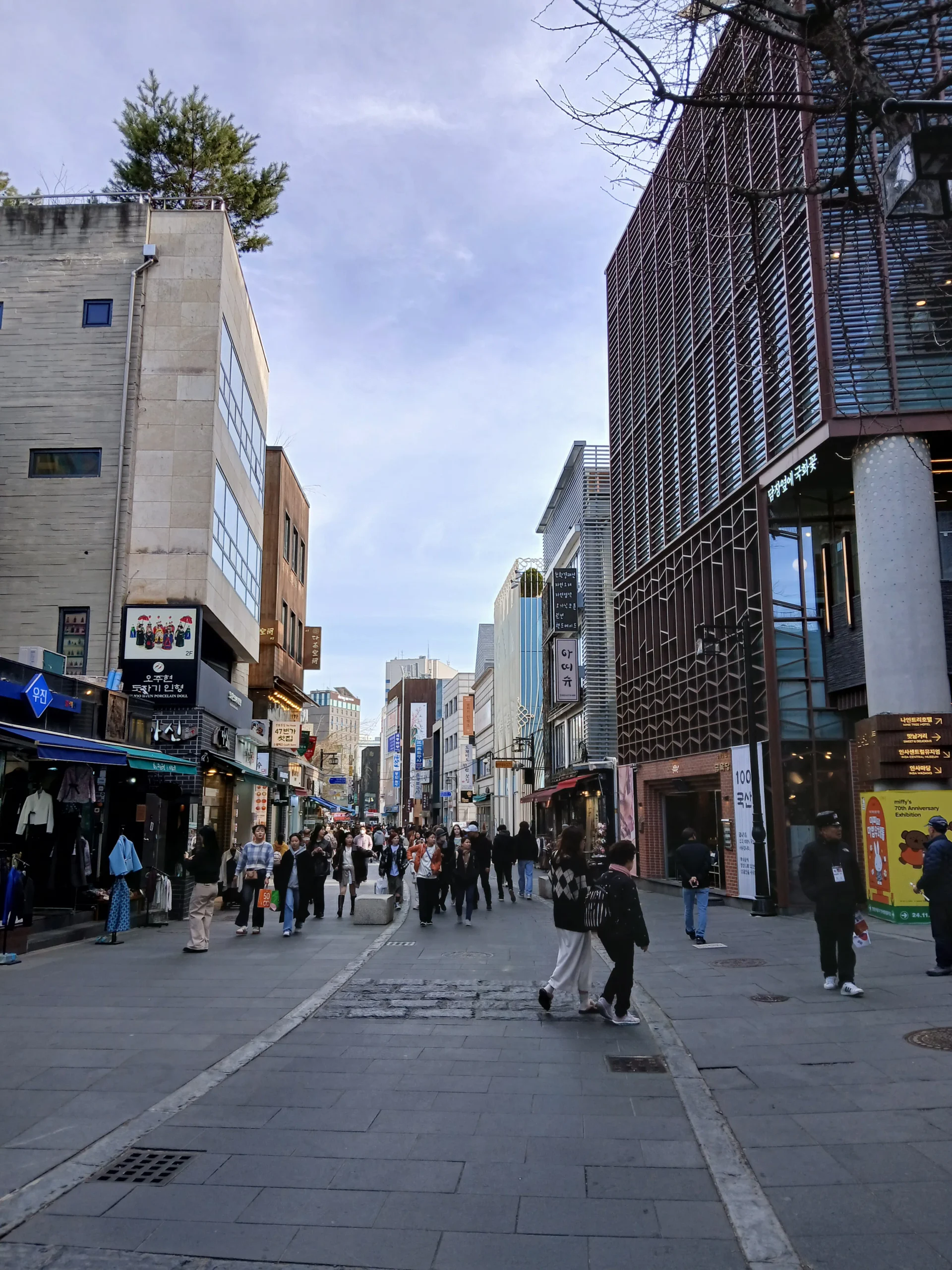 Pedestrians walking along Insadong-gil between shops in central Seoul