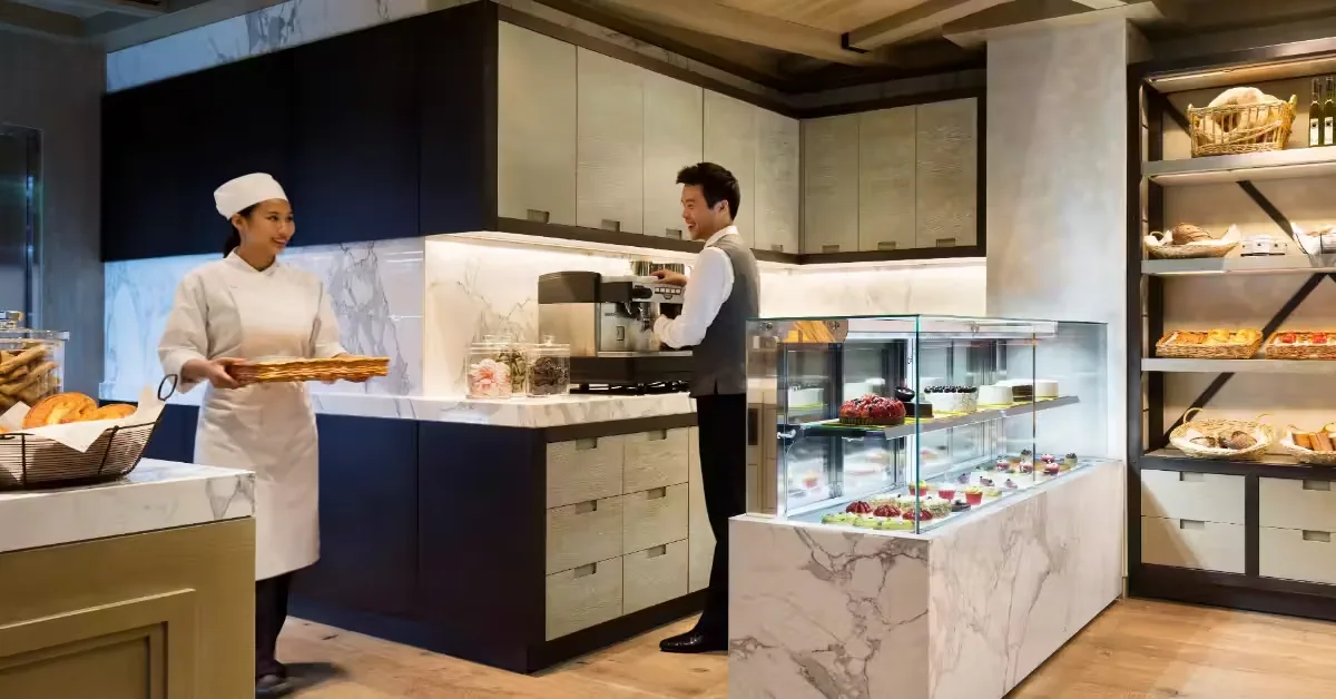Hotel staff at a pastry and dining counter inside JW Marriott Dongdaemun Square Seoul