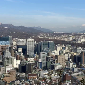 Daytime view across central Seoul and distant mountains from Sejong Hotel
