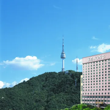 Sejong Hotel building beside the green slope of Namsan and N Seoul Tower